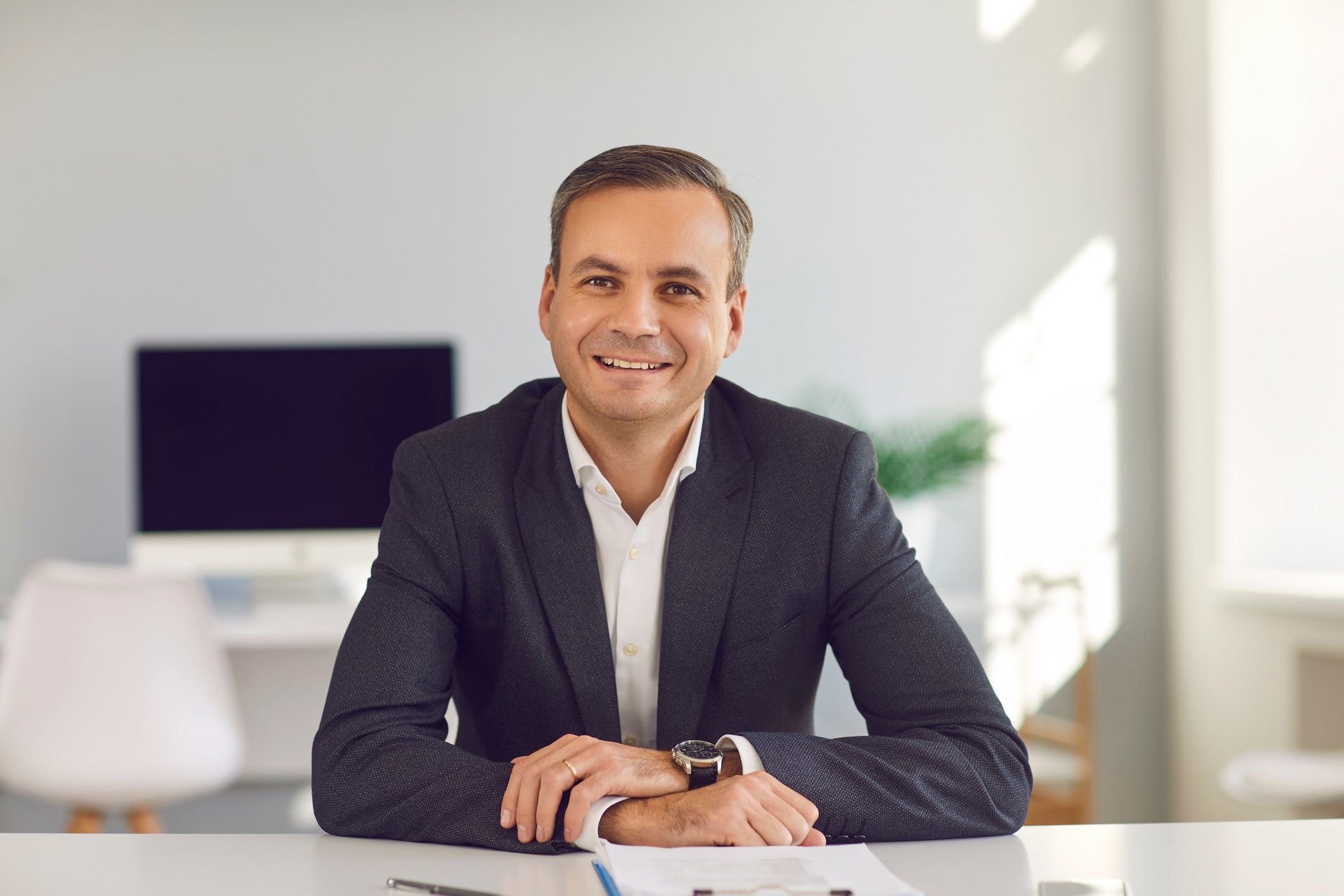 Smiling Middle Aged Businessman Looking at Camera during Online Videocall or Interview